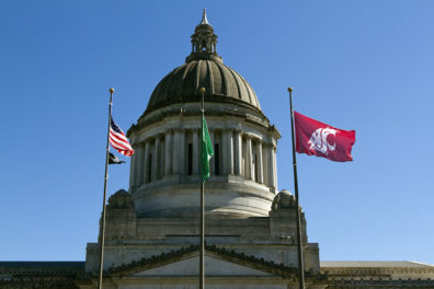 Washington State Capitol building with US, state and WSU flags flying in front.