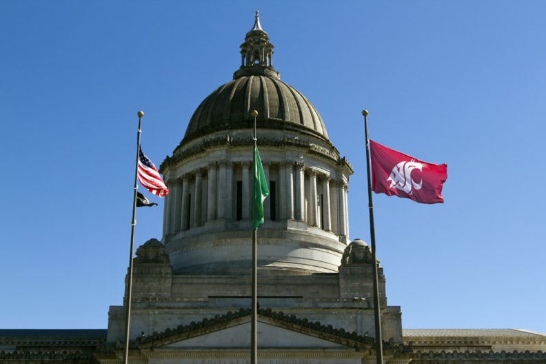 Washington State Capitol building with US, state and WSU flags flying in front.