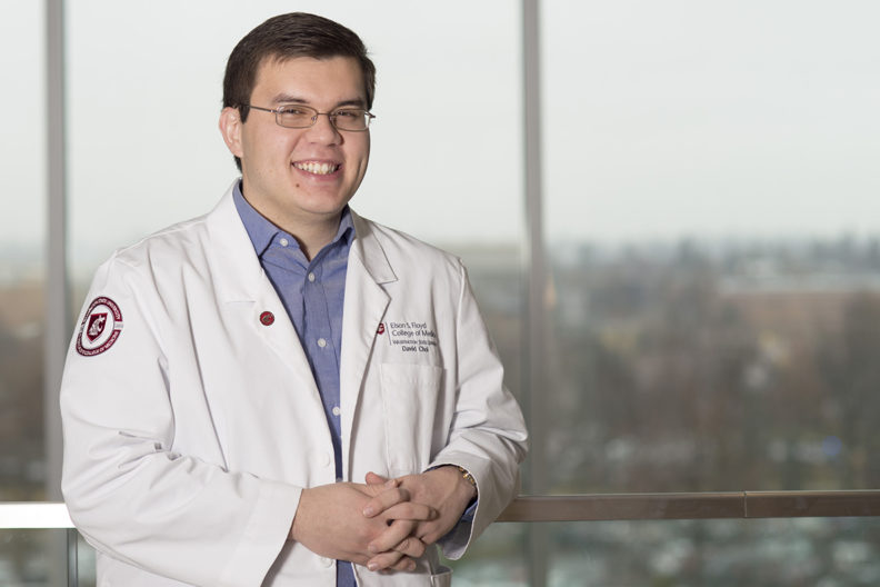 Closeup of Choi in white medical coat at WSU Spokane.