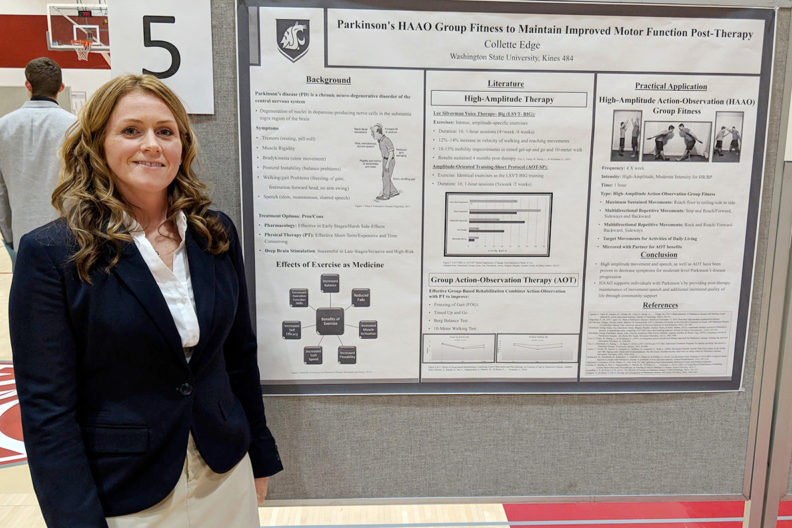 Edge standing beside research poster.