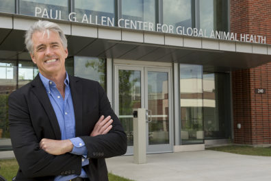 Palmer standing outside the main entrance of the Global Animal Health building.