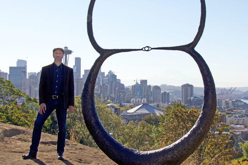 Schultheis stands beside one of his art pieces.