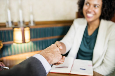 Man and woman shaking hands.