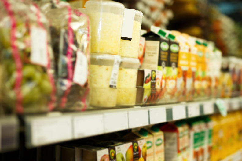 Long shelves of packaged food in food bank.
