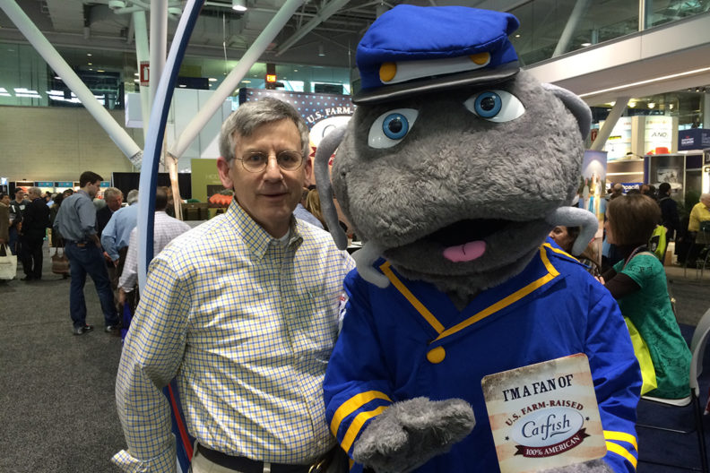 Donegan and a Ivars catfish mascot standing next to him in the Seattle Market