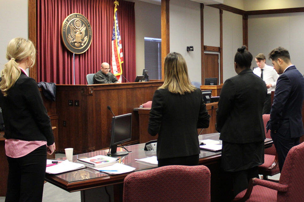 WSU Mock Trial team and Filer presenting mock case in courtroom.