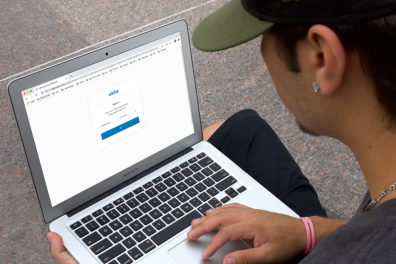 A student setting up an Okta account on his laptop.