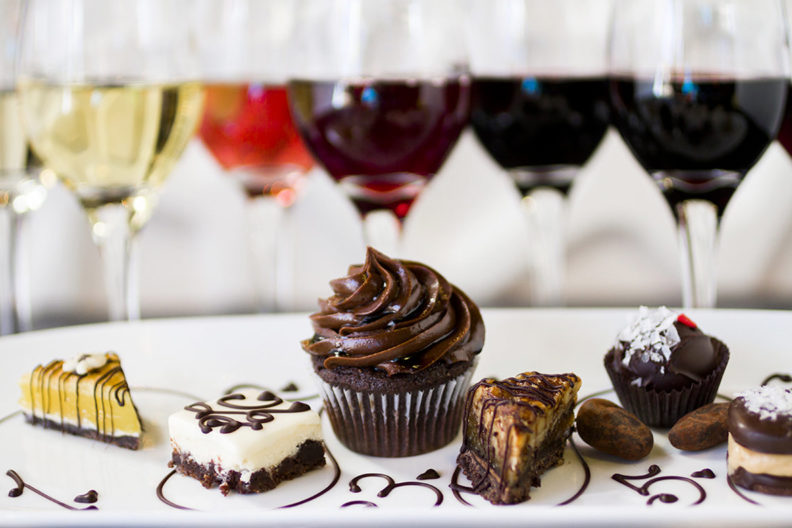 Glasses of wine and an assortment of chocolates.