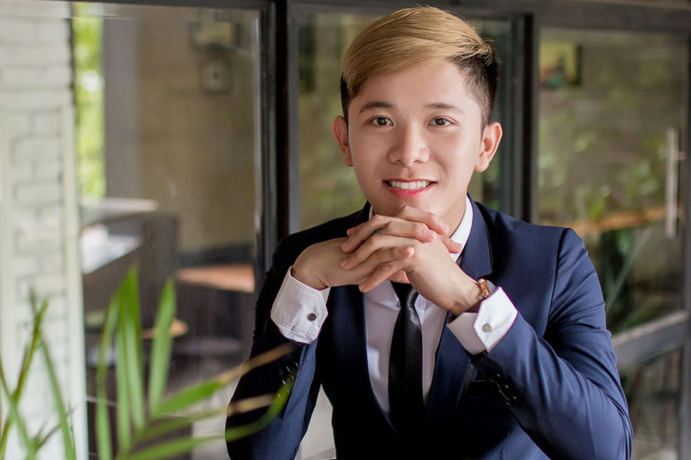 Closeup of Nam Nguyen standing on balcony.