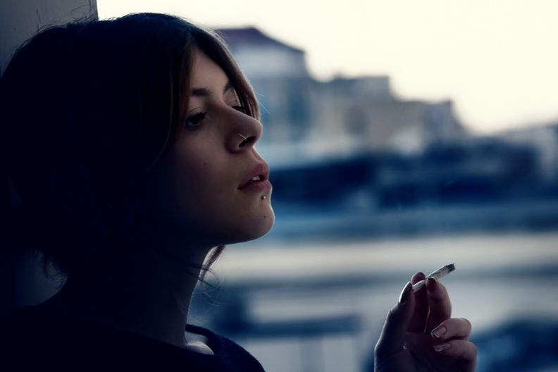 Teenage girl smoking marijuana.