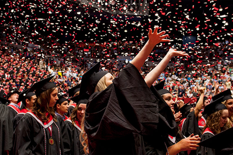 Students celebrating at a commencement ceremony.