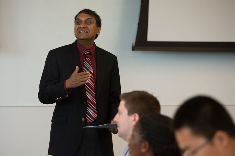 Arvin Sahaym lectures in front of students.