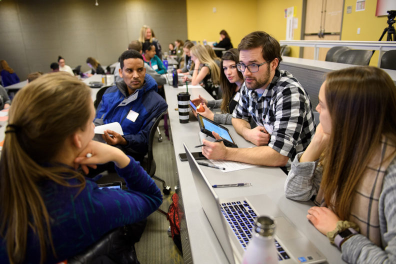 Students interacting in a classroom.