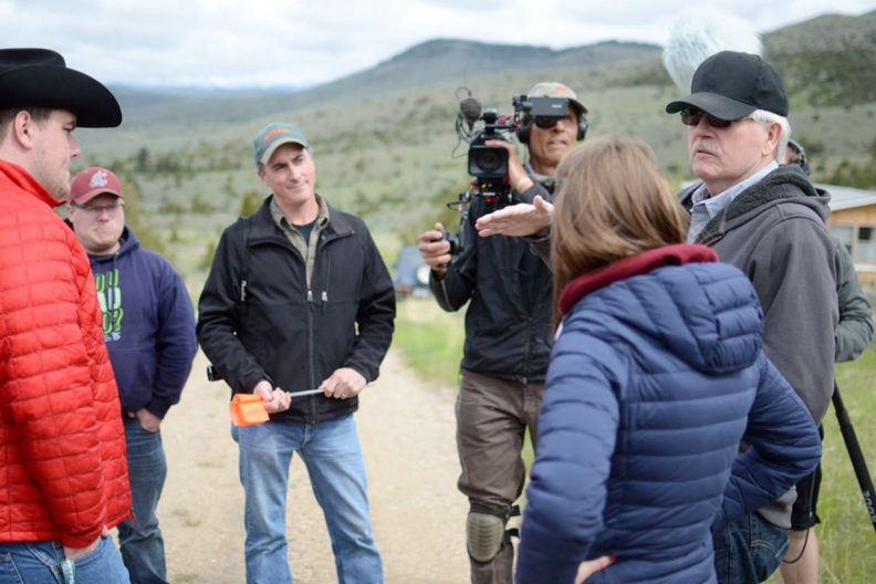 Documentary filmmakers interviewing people on location.