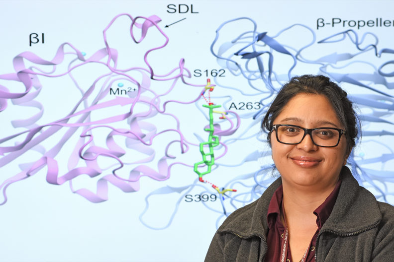 Closeup of Swechha Pokharel in front of scientific diagram.