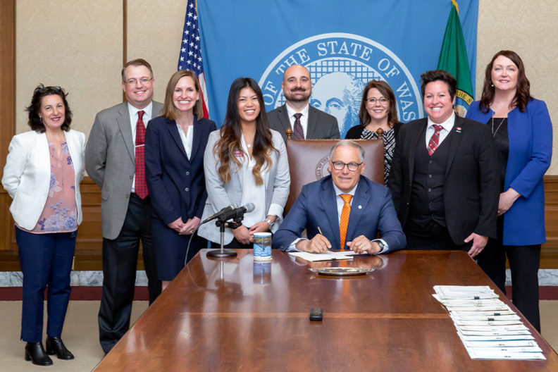 Gov. Jay Inslee signs a bill into law.