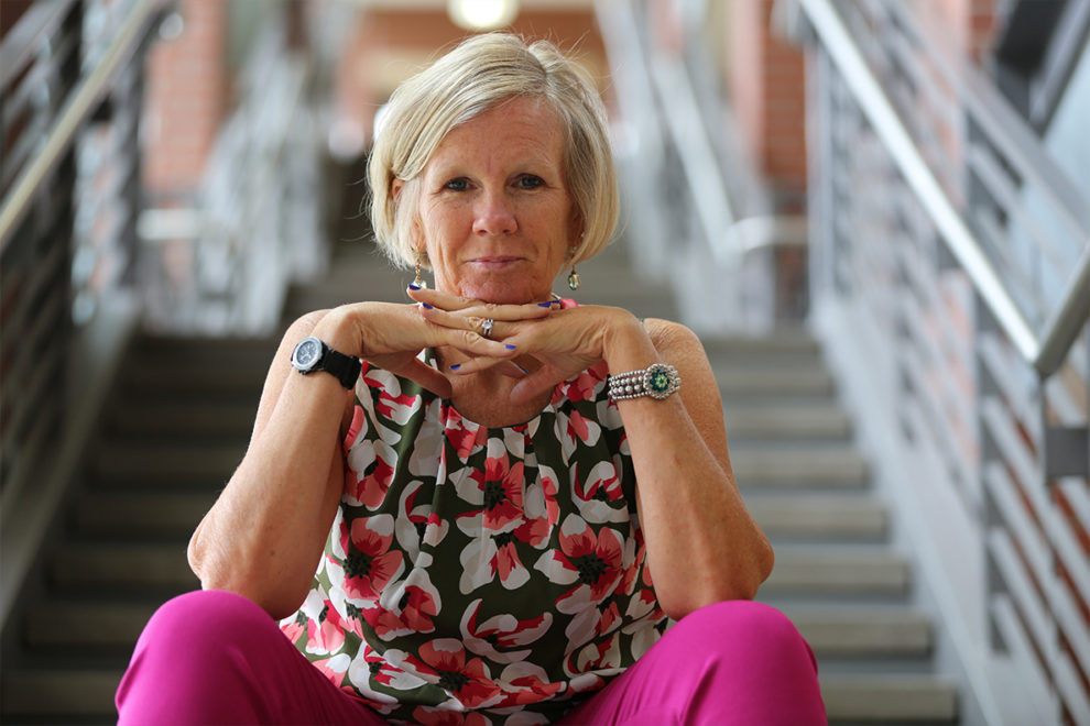 Kelly Ward sitting at the bottom of a staircase.