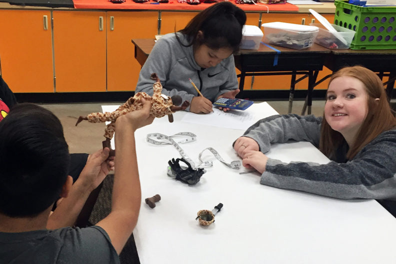 Mathematics student Catherine Lindner, right, helps Nespelem, Wash., middle school students.