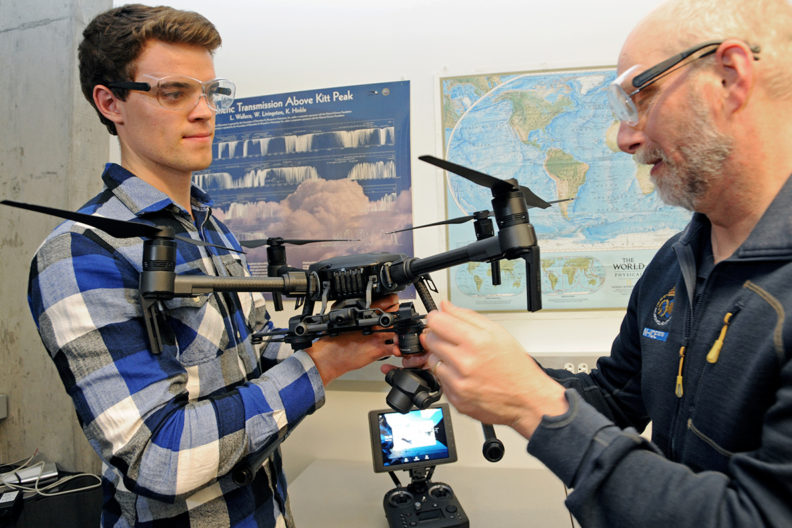 Gubsch and Walden adjusting a drone.