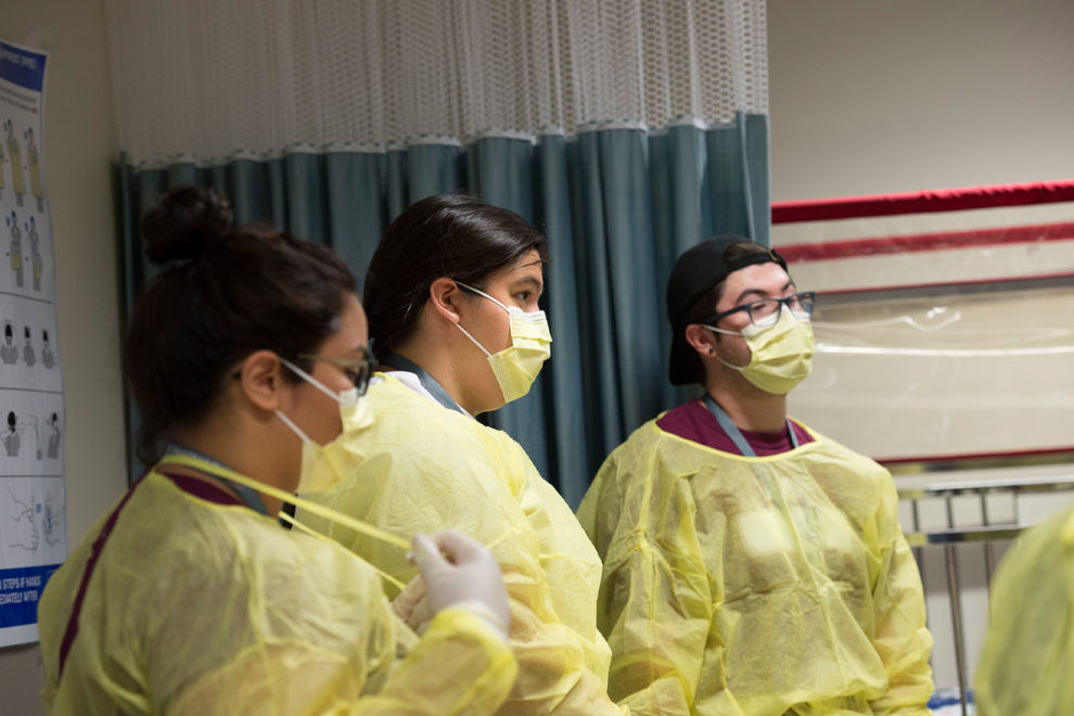Native Americans students observing a medical procedure.