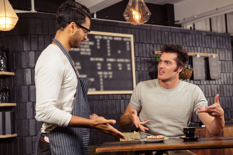Customer and waiter arguing with one another.