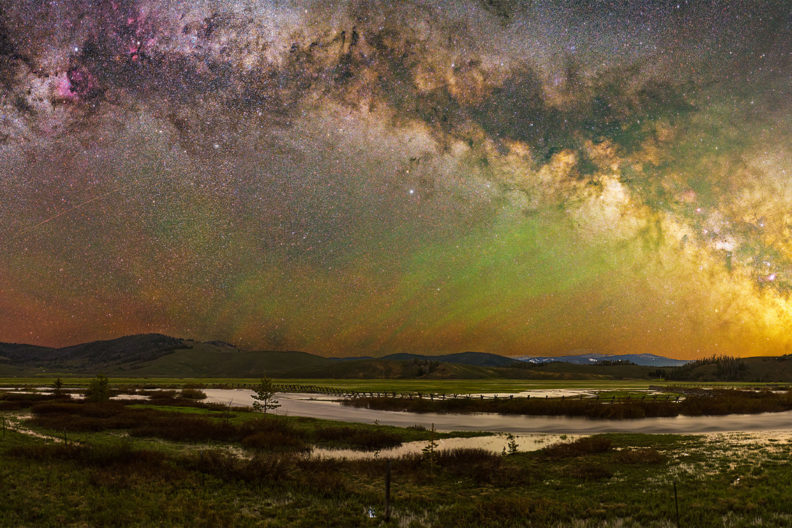A clear night sky over a natural backdrop