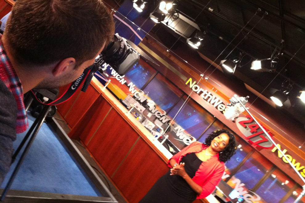Shaniqua Manning standing in front of a camera on the Northwest Cable News set.