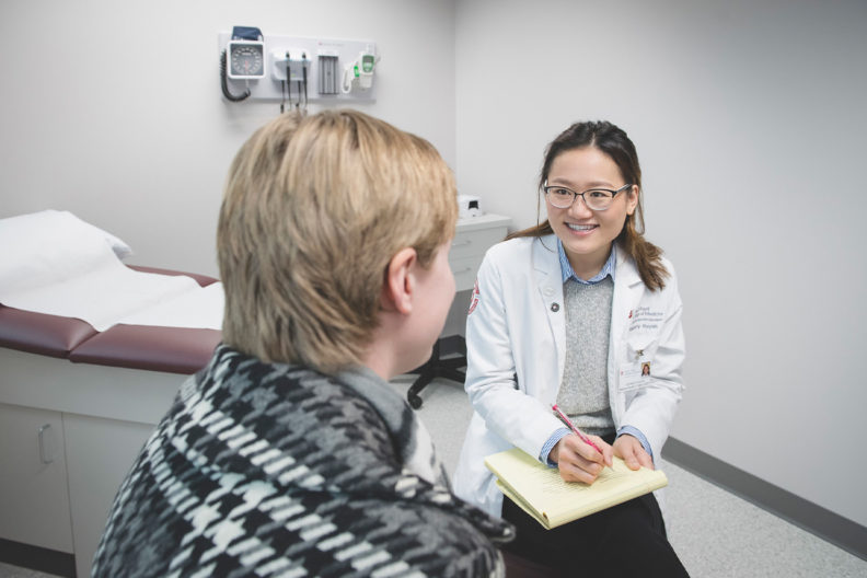 A medical student interviews a patient.