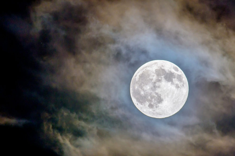 The moon glowing in the night sky.