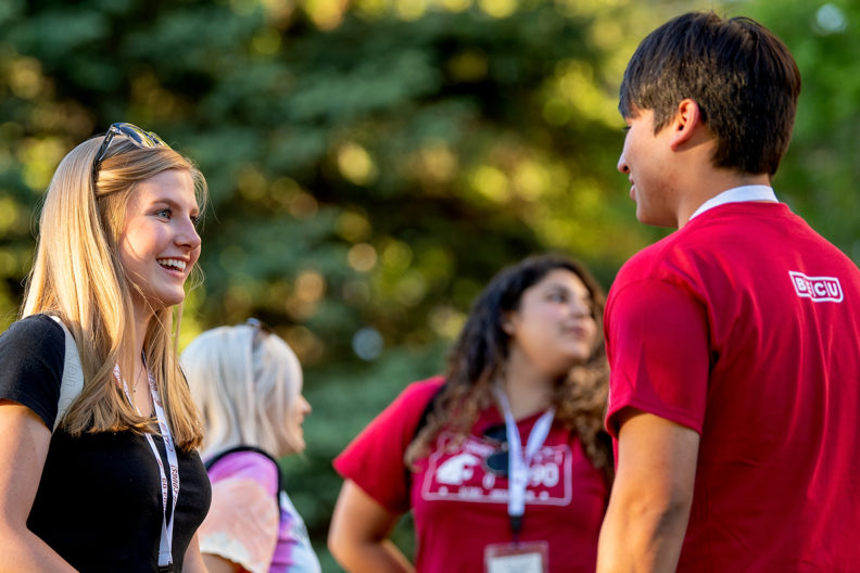Students talking to one another on campus.