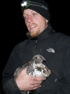 Kyle Ebenhoch holding a sage-grouse.