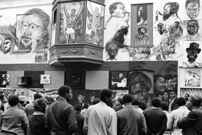 People standing in front of Chicago's 'Wall of Respect'.