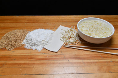 WSU's newest spring wheat shown on a table in various stages from grain to noodles.