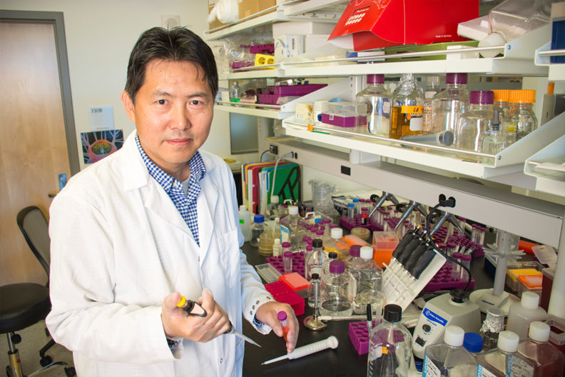 Closeup of Zhenjia Wang in a laboratory.