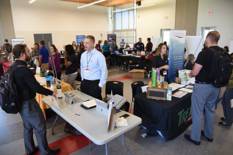 A photograph of booths at a career fair.