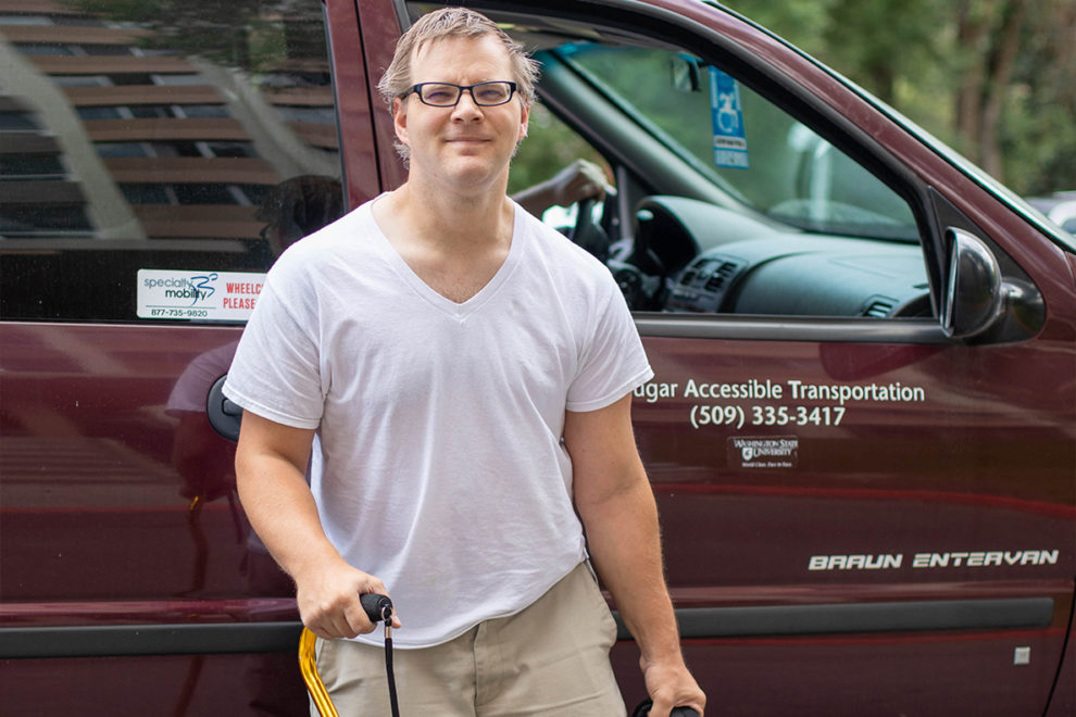 Sport management graduate student Brandon Viall gets ready to board a CATS ride in front of his residence hall.