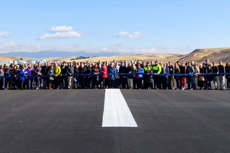 People gather on the PUW runway to celebrate its reopening.