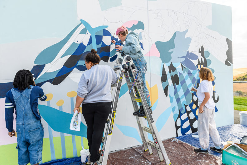 Students working on a mural