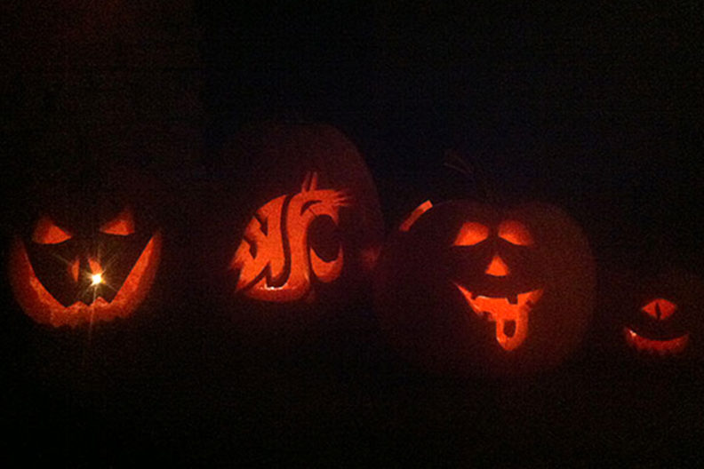 Four jack-o-lanterns, each with a different face.