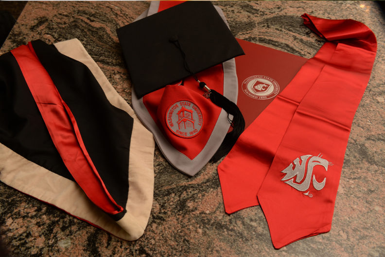 A photograph of WSU regalia scattered on a table