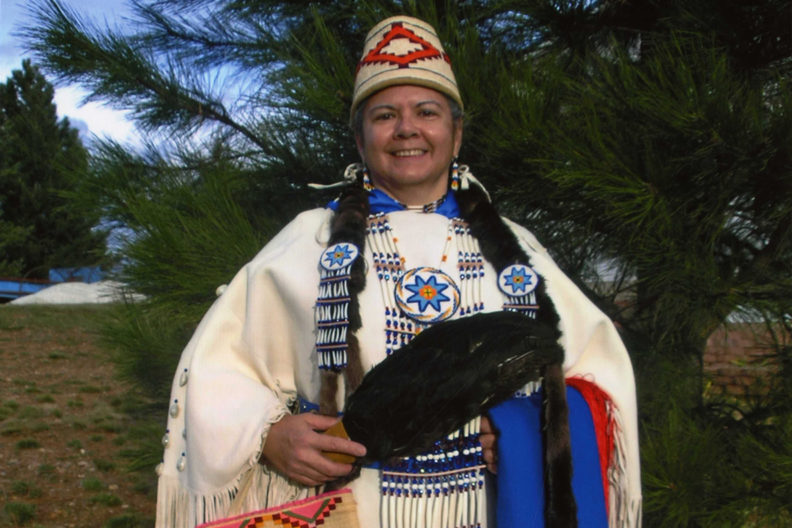 Closeup of Robbie Paul in traditional Native American dress.