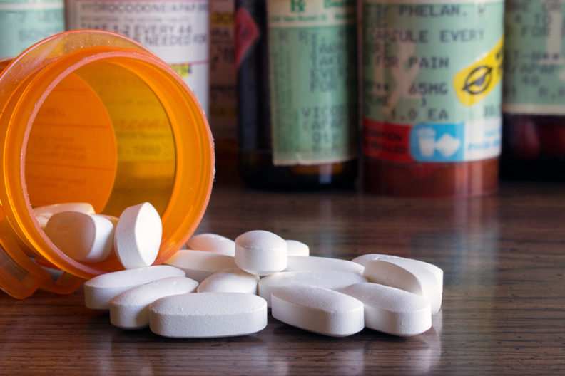 Closeup of pills and pill bottles.