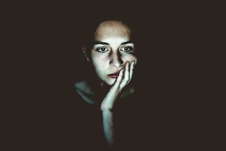 Closeup of a bored-looking young woman.