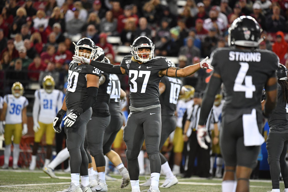 Justus Rogers directs his fellow Cougar football players on the field.