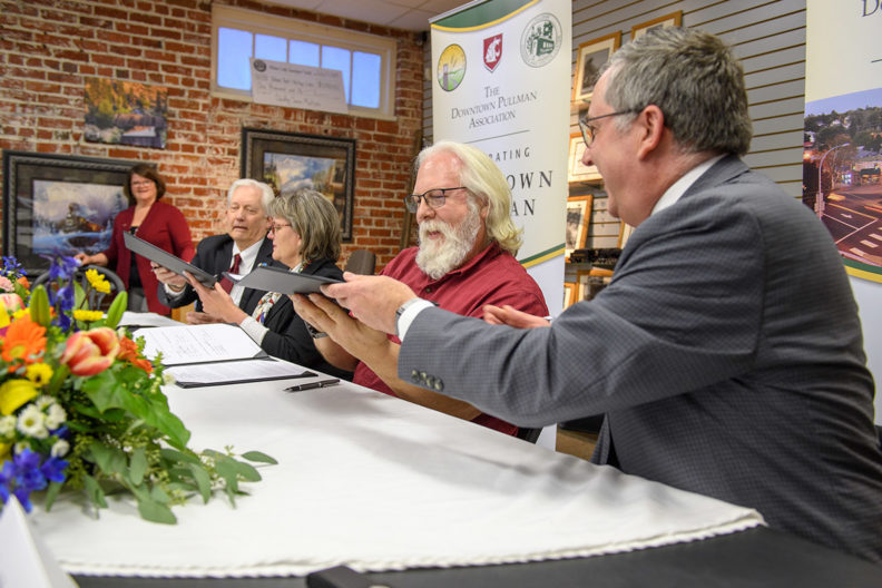 Kirk Schulz and other representatives signing a memorandum of understanding.