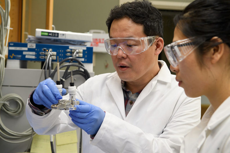 Professor Min-Kyu Song and graduate student Panpan Dong test a prototype of a lithium metal battery.