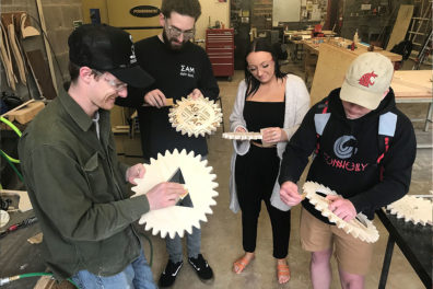 Digital Design and Fabrication students sand and perfect their cogwheels.