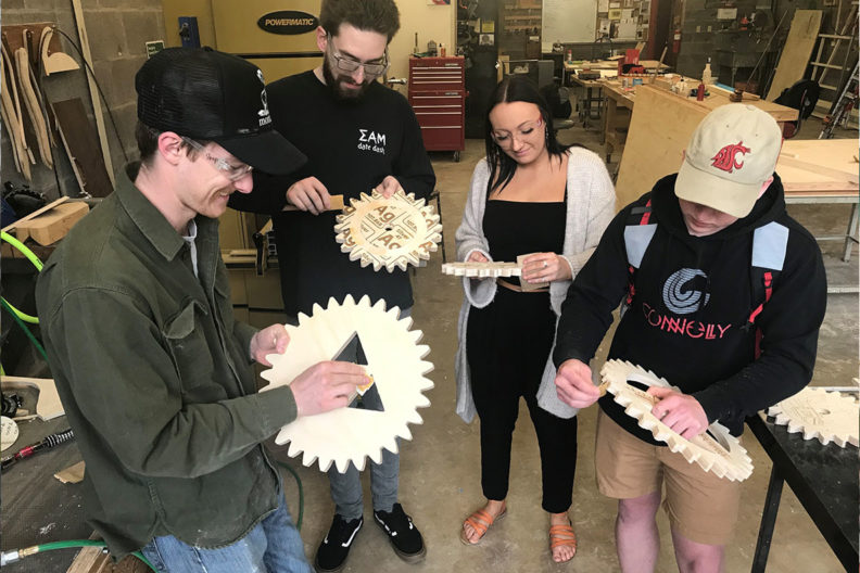 Digital Design and Fabrication students sand and perfect their cogwheels.