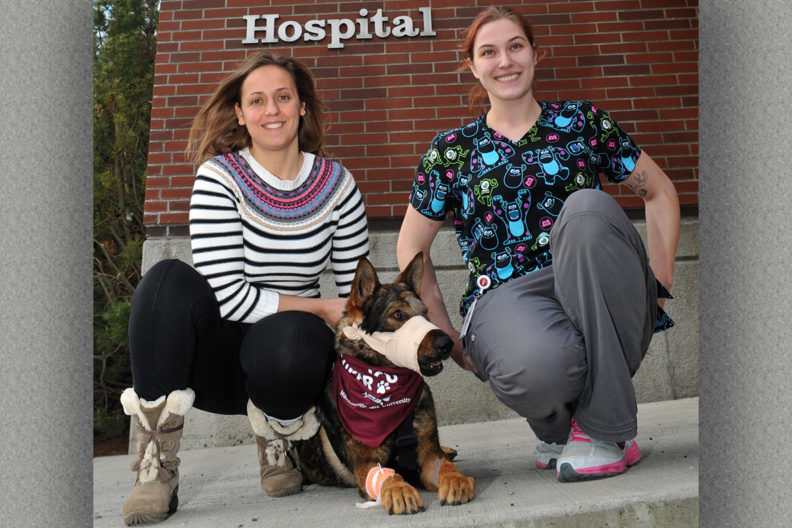 Emilia Terradas and McKenzie Dress on a sidewalk with Chief.