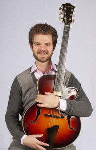 Closeup of Gabe Condon with a guitar